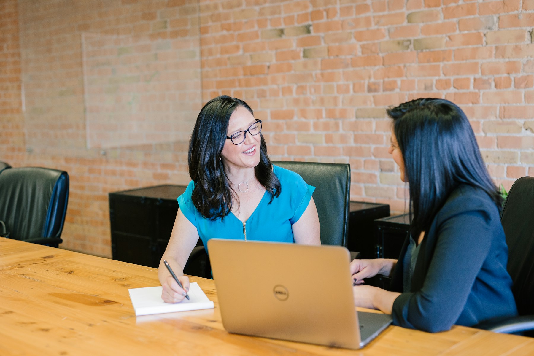 Two colleagues in a working session across a conference table